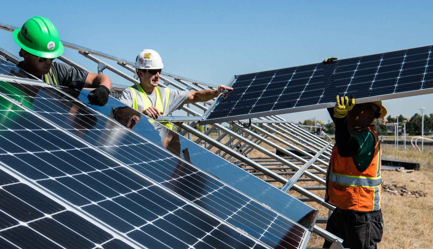 RE Supply installers working with solar panels